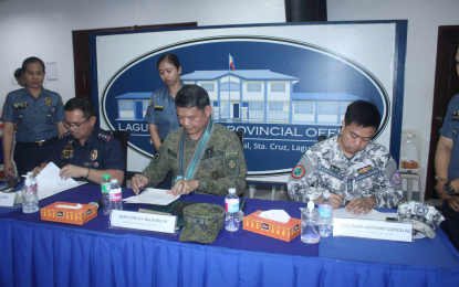 <p><strong>WORKING TOGETHER.</strong> Col. Gauvin Mel Unos (left to right) of the Philippine National Police, Brig. Gen. Cerilo Balaoro Jr. of the Philippine Army, and Lt. Junior Grade Mark Anthony Cuevillas of the Philippine Coast Guard on Wednesday (April 10, 2024) sign a joint legal cooperation agreement on behalf of their agencies. The pact provides for closer collaboration between the three entities in Laguna province. <em>(Photo courtesy of Laguna Provincial Police Office)</em></p>