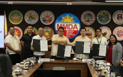 <p><strong>PARTNERSHIP.</strong> Metropolitan Manila Development Authority Acting Chair Romando Artes and Philippine Health Insurance Corporation president Emmanuel Ledesma Jr. (4th and 5th from left) during the signing of a memorandum of agreement at the MMDA headquarters in Pasig City on Monday (April 15, 2024). The MMDA medical clinic was accredited as a Konsulta Package Provider, improving the healthcare benefits of the agency's workforce and their dependents. <em>(Photo courtesy of MMDA)</em></p>