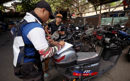 <p><strong>APPREHENDED.</strong> A Manila Traffic and Parking Bureau personnel attend to owners of impounded electric bicycles and tricycles caught traversing national roads at their headquarters in Ermita, Manila, on April 15, 2024. President Ferdinand R. Marcos Jr. has granted e-trike and e-bike owners a one-month grace period before imposing the rule banning them from national roads. <em>(PNA photo by Yancy Lim)</em></p>