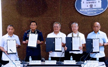 <p><strong>ANTI-DRUG WAR IN PRISONS.</strong> Philippine Drug Enforcement Agency Director General Moro Virgilio Lazo (starting from left), Philippine National Police Chief Gen. Benjamin Acorda Jr., Bureau of Corrections Director General Gregorio Pio Catapang Jr., National Bureau of Investigation Director Medardo de Lemos and NICA Assistant Director General for Counter Intelligence Rolando Asuncion sign a memorandum of agreement for an inter-agency Operations Center at the New Bilibid Prison in Muntinlupa City on Oct. 10, 2023. The operations center, which was inaugurated Monday (April 15, 2024), aims to strengthen the campaign against illegal drugs that continue to plague penal facilities nationwide. <em>(PNA photo by Avito C. Dalan)</em></p>