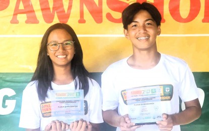 <p><strong>WINNERS.</strong> Cadee Jan Dagoon (left) and Samuel Davila hold their trophies during the awarding ceremony of the Palawan Pawnshop-Palawan Express Pera Padala National Tennis Championship at Village East Tennis Club in Cainta, Rizal on Sunday (April 14, 2024). Dagoon bagged her second girls' U-14 title while Davila ruled the boys' U-18 division. <em>(Contributed photo)</em></p>