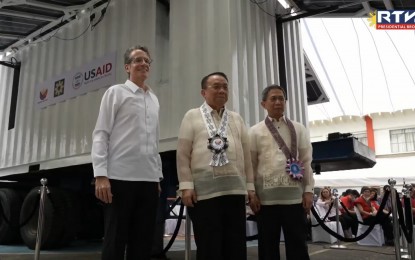 <p><strong>ENERGY RESILIENCE</strong>. Representing President Ferdinand R. Marcos Jr., Executive Lucas Bersamin (middle) leads the inauguration of the Energy Sector Emergency Operations Center and the Mobile Energy System at the Energy Center in Bonifacio Global City, Taguig City on Monday (April 15, 2024). The two initiatives, designed to address the need for resilient energy infrastructure and response capabilities in times of crisis, are part of the United States Agency for International Development’s $34 million "Energy Secure Philippines" program with the Department of Energy.<em> (RTVM Screengrab)</em></p>