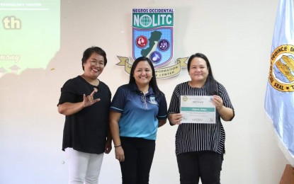 <p><strong>GRADUATION RITES.</strong> Four hearing-impaired learners and two persons with special needs are the pioneer graduates of certification courses at the Negros Occidental Language and Information Technology Center in Bacolod City. Vocational school administrator Ma. Cristina Orbecido (center) with Bacolod Integrated Deaf Association president Lafonza Latoza (right) and coordinator Joan Briones are shown during the culmination ceremony on April 12, 2024. <em>(Photo courtesy of Negros Occidental Language and Information Technology Center)</em></p>