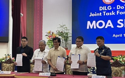 <p><strong>NO TO COLORUM.</strong> Interior Secretary Benjamin Abalos Jr. (center); DOTr Secretary Jaime Bautista (2nd from left), and MMDA acting chair Don Artes (2nd from right) sign a memorandum of agreement to intensify joint operations against colorum vehicles in simple rites at Camp Crame, Quezon City on Wednesday (April 17, 2024). Under the pact, the DILG, through its Special Project Group of the Philippine National Police, the DOTr, and the MMDA, shall create a Joint Task Force to conduct traffic, clearing, and anti-colorum operations within Metro Manila. <em>(PNA photo by Lloyd Caliwan)</em></p>