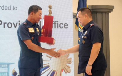 <p><strong>WINNING STREAK</strong>. Brig. Gen. Paul Kenneth Lucas (left), Calabarzon police director, hands the award for best performing provincial command to Laguna police chief Col. Gauvin Mel Unos at Camp Vicente P. Lim in Calamba City on Monday (April 22, 2024). The Laguna police also took the same award in December 2023 and January 2024.<em> (Photo courtesy of LPPO)</em></p>
