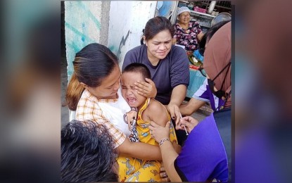 <p><strong>INOCULATED.</strong> A child in Parang, Maguindanao del Norte, gets an anti-measles shot from barangay health workers on Monday (April 22, 2024). Officials from the BARMM health ministry said the anti-measles campaign in the region that started on April 1 will continue until May 10, 2024. <em>(Photo from Parang RHU)</em></p>