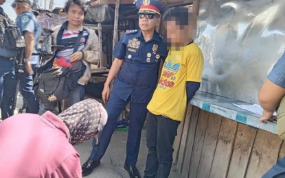 <p><strong>SURPRISED.</strong> Police operatives handcuff a suspected drug peddler (in yellow shirt) after he sold a sachet of suspected “shabu” drugs to a poseur buyer in Barangay Limbo, Sultan Kudarat, Maguindanao del Norte, on Monday (April 22, 2024). Seized from him were more than PHP2.7 million worth of “shabu” drugs.<em> (Photo courtesy of Maguindanao Norte PPO)</em></p>