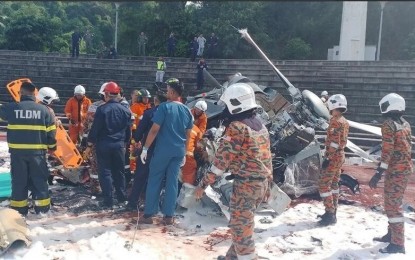 <p><strong>RETRIEVAL.</strong> Emergency personnel work at the site of a helicopter crash in Lumut, Perak, Malaysia on April 23, 2024. Two Malaysian navy helicopters collided in mid-air during a rehearsal for a naval parade and all 10 crew involved have been confirmed dead. <em>(Anadolu)</em></p>