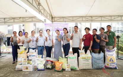 <p><strong>DISTRIBUTION</strong>. La Union Governor Raphaelle Veronica Ortega-David (middle) poses with representatives of farmer-groups during the distribution of farm inputs in this undated photo. The farm inputs were given in preparation for the upcoming wet cropping season. <em>(Photo courtesy of province of La Union)</em></p>