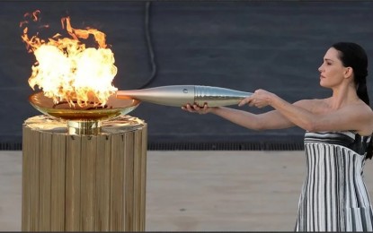 <p><strong>TORCHBEARER. </strong> Greece hands the Olympic flame to Paris 2024 organizers in a ceremony on Friday (April 26, 2024) in the Panathenaic stadium in central Athens.  It is expected to arrive in Paris on May 8 and will be received by the first torchbearer, French swimmer Florent Manaudou. <em>(Anadolu)</em></p>