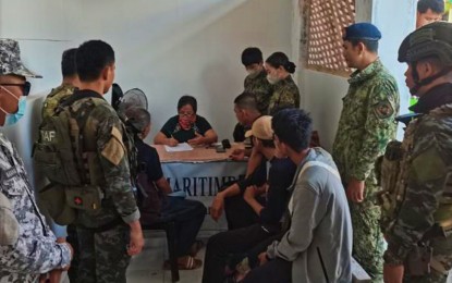 <p><strong>DOCUMENTATION.</strong> An official of the local inter-agency committee against human trafficking conducted documentation on the rescued individuals believed to be victims of human trafficking in Bongao, Tawi-Tawi, on Saturday (April 27, 2024). At least 14 human trafficking victims bound for Malaysia aboard a sea vessel were rescued during the operation. <em>(Photo courtesy of PRO-BAR)</em></p>