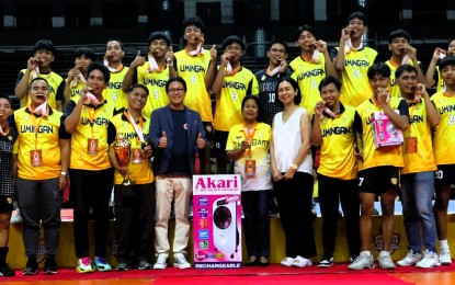<p><strong>WINNING TEAM. </strong>Umingan of Pangasinan won the boys' title in the Philippine National Volleyball Federation Under-18 Championships at Rizal Memorial Coliseum in Manila on Sunday (April 28, 2024). Coach Eusebio Solis (standing with trophy, 4th from left) said the victory proved that provincial teams can be at par with squads from big cities. <em>(PNVF photo)</em></p>