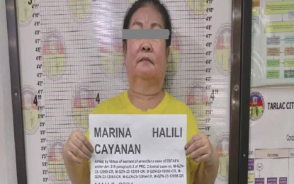 <p><strong>ARRESTED.</strong> Marina Cayanan, 59, is arrested by the Quezon City Police District Cubao Station 7 in Tarlac City on Friday (May 3, 2024). She had a warrant of arrest for six counts of estafa. <em>(QCPD photo)</em></p>