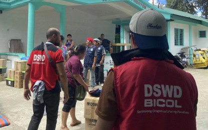 <p><strong>GOV’T AID.</strong> Department of Social Welfare and Development-Bicol (DSWD-5) personnel distribute food and non-food items to the victims of a fire incident in Masbate City that occurred on May 2, 2024. The 17 affected families also received financial assistance in rebuilding their homes.<em> (Photo courtesy of DSWD Bicol)</em></p>