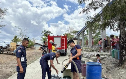 <p><strong>ASSISTANCE.</strong> Bureau of Fire Protection (BFP) personnel assist in water rationing in Barangay Igsuming, Sibalom, on Monday (May 6, 2024). Vice Governor Edgar Denosta, in an interview, said that the provincial government started releasing water tanks, jetmatic pumps, and hosepipes to barangays suffering from water scarcity today. (<em>Photo courtesy of the BFP Sibalom)</em></p>