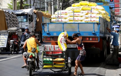 <p><strong>RICE.</strong> Workers unload sacks of rice at a warehouse in Tondo, Manila, on May 7, 2024. President Ferdinand R. Marcos Jr. has prioritized the amendments to the Rice Tariffication Law to bring down the price of rice in the retail market. <em>(PNA photo by Yancy Lim)</em></p>