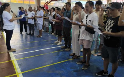 <p><strong>GOV'T AID</strong>. Alona Party-list Rep. Anna Villaraza-Suarez (left) leads the oath-taking of the LGBTQIA+ group leaders from 12 towns of Quezon's Bondoc Peninsula area in Gen. Luna town on Wednesday (May 8, 2024). Some 784 members of the group also received PHP3,000 each under DSWD's Assistance to Inviduals in Crisis Situation program. <em>(Photo by Belinda Otordoz)</em></p>