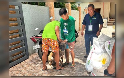 <p><strong>FIGHTING RABIES</strong>. A domesticated dog receiving an anti-rabies shot from a municipal worker in Odiongan, Romblon in this undated photo. Government veterenarians in the province have been going house-to-house to innoculate dogs and cats against the dreaded disease. <em>(Photo courtesy of the Provincial Department of Health Office)</em></p>