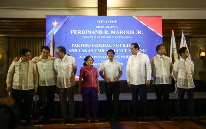 <p><strong>COLLABORATION. </strong>President Ferdinand R. Marcos Jr. (5th from left) poses with key officials after the merger signing between his political party, Partido Federal ng Pilipinas, and Lakas-Christian Muslim Democrats at Manila Polo Club in Makati City on Wednesday (May 8, 2024). Also in photo are Special Assistant to the President Anton Lagdameo Jr.; Lakas-CMD chairperson emeritus, former president and Pampanga 2nd District Rep. Gloria Macapagal Arroyo; and Lakas-CMD president and House of Representatives Speaker Martin Romualdez of Leyte's 1st District (3rd, 4th and 6th from left).<em> (PNA photo by Joan Bondoc)</em></p>