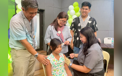 <p><strong>IMMUNIZED.</strong> Banna, Ilocos Norte Mayor Mary Chrislyn Abadilla, a doctor herself, administers HPV vaccine to Athena Ysabel Bonilla on Friday (May 10, 2024). The town of Banna is the first to achieve 90 percent vaccination of girls aged 9-14 towards eliminating cervical cancer nationwide.<em> (Photo by Leilanie Adriano)</em></p>