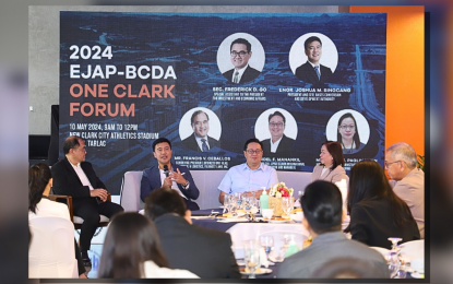 <p><strong>BUYING STAKE</strong>. Bases Conversion and Development Authority president and chief executive officer Joshua Bingcang (2nd from left) tells a forum that Metro Pacific Tollways Corp. has formally expressed interest to buy BCDA's shares in the Subic-Clark-Tarlac Expressway. Bingcang made the statement at the Economic Journalists Association of the Philippines-BCDA Group One Clark Forum at the New Clark City Athletics Stadium in Capas, Tarlac on May 10, 2024. <em>(Courtesy of BCDA)</em></p>