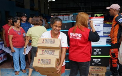 <p><strong>GOV’T AID</strong>. Some 266 families from Barangay Siana, Mainit, Surigao del Norte, are provided with food and other necessities by the Department of Social Welfare and Development-Caraga Region in a distribution activity on May 12, 2024. They were evacuated after a landslide a day before.<em> (Photo courtesy of DSWD-13)</em></p>