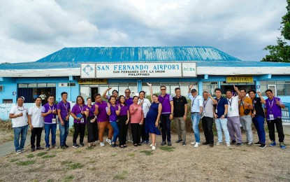 <p><strong>AIR TRAVEL</strong>. La Union Governor Raphaelle Veronica Ortega-David (in a blue dress) poses with officials and staff of the provincial government during a visit to the San Fernando Airport at Poro Point, San Fernando City, La Union in this undated photo. The provincial government is eyeing to resume domestic commercial flight operations at the airport.<em> (Photo courtesy of Province of La Union)</em></p>