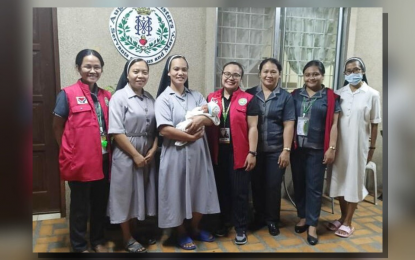 <p><strong>RESCUED.</strong> A nun holds the 8-day old boy rescued by the Philippine National Police-Women and Children Protection Center in Tagaytay City, Cavite on May 15, 2024 after his mother attempted to sell him through a broker. He is now under the care of the Augustinian Sisters at the Mother Teresa Spinelli Retreat House in Tagaytay. <em>(DSWD photo)</em></p>