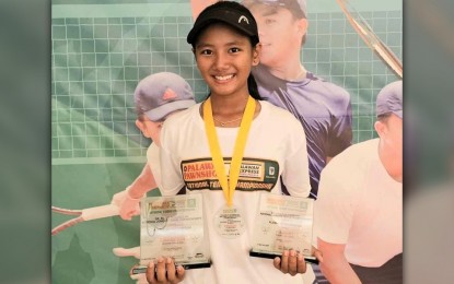 <p><strong>TOP JUNIOR NETTER.</strong> Olongapo City's Jan Cadee Dagoon holds the girls' 14-under (champion) and 16-under (runner-up) trophies during the awarding ceremony of the Dr. Pablo Olivarez Sr. National Junior Tennis Championships in Parañaque on May 13, 2024. She is among the title contenders at the Calderon Cup scheduled in Roxas, Isabela from May 24 to 27, 2024. <em>(Contributed photo)</em></p>