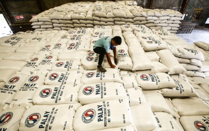 <p><strong>ADEQUATE RICE STOCKS.</strong> A warehouse staff inspects sacks of palay (unhusked rice) bought from farmers at the National Food Authority (NFA) in Balagtas, Bulacan on May 22, 2024. NFA officer-in-charge administrator Larry Lacson on Monday (May 27) reported that the agency has tripled the volume of rice buffer stock from 45,000 metric tons (MT) to 126,000 MT as the NFA prepares for the looming La Niña. <em>(PNA photo of Joan Bondoc)</em></p>