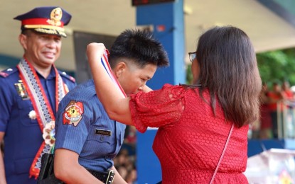 <p><strong>CREAM OF THE CROP</strong>. Charisse Ann Avisado receives her medal as the top student of the 299-strong Mabanaag Class of the Philippine National Police's Public Safety Basic Recruit Course at Camp Simeon Ola, Legazpi City, Albay on Friday (May 24, 2024). Avisado and her classmates will next undergo field training around the Bicol Region.<em> (Photo courtesy of PRO5)</em></p>