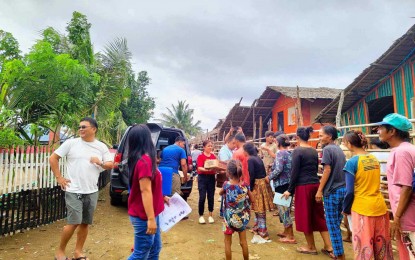 <p><strong>DISPLACED.</strong> Department of Social Welfare and Development staff distribute family food packs to residents displaced by the effects of Typhoon Aghon in Pasacao, Camarines Sur on Sunday (May 26, 2024). Sixty-two families who preemptively evacuated Saturday due to possible landslides, storm surges, and floods have returned home. <em>(Photo courtesy of DSWD)</em></p>