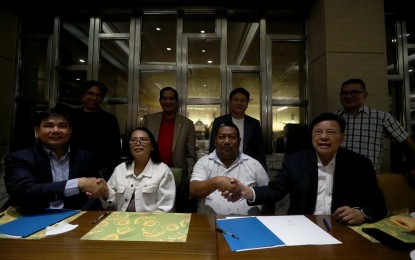 <p><strong>BLUE ECONOMY.</strong> Michael Abundo, chief executive officer of OceanPixel; Mayor Angelie Arcena of Burgos, Surigao del Norte; Mayor Lamberto Domingos Jr. of San Isidro, Surigao del Norte; and Augusto Baculio, president of Orbits Satellite Corp., sign a memorandum of understanding on blue economy at the Manila Hotel on Wednesday (May 29, 2024). The tie-up aims to position San Isidro and Burgos as “model for integrated blue economy practice,” which OceanPixel and Orbits believe will eventually attract investments on the island. <em>(PNA photo by Yancy Lim)</em></p>