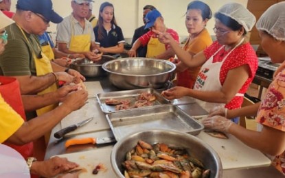 <p><strong>HANDS-ON DEMONSTRATION</strong>. Members of the Tanauan City Fishermen Marketing Cooperative (TFMC) receive training on techniques in filleting, deboning, and drying fish to preserve its quality and taste in this undated photo. The cooperative members were trained on using the fish dryer to maximize the efficiency of the drying process and reduce the risk of contamination. <em>(Photo courtesy of Batangas PSTO)</em></p>