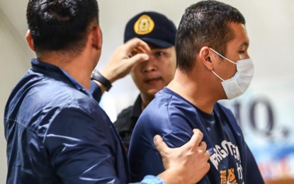 <p><strong>HOTHEAD.</strong> Gerrard Raymund Yu (with mask), the suspect in the fatal road rage shooting in Makati City, arrives in Camp Crame, Quezon City on Wednesday (May 29, 2024). The 34-year-old suspect shot dead a family driver, 65, following a traffic altercation around 2:30 p.m. Tuesday (May 28). <em>(PNA photo by Joan Bondoc)</em></p>