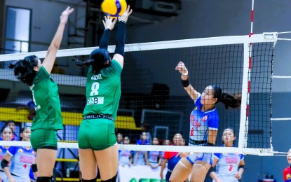 <p><strong>SCORE. </strong>Catherine Chu of Arellano University (right) scores off Sabine Valdez (No. 8) and Margarita Tanada of De La Salle-Zobel during the Shakey’s Girls Volleyball Invitational League preliminaries at Paco Arena in Manila on Tuesday (June 4, 2024). Arellano won, 25-21, 17-25, 25-20, to earn a quarterfinal berth. <em>(Shakey's GVIL photo)</em></p>