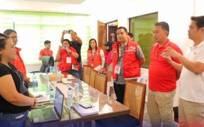 <p><strong>BETTER MEANS.</strong> The Department of Social Welfare and Development-Western Visayas Field Office and La Castellana, Negros Occidental officials led by Mayor Alme Rhummyla Mangilimutan discuss strategies that will further improve the ongoing relief operations for families affected by the Mt. Kanlaon eruption in this undated photo. They agreed to conduct psychosocial interventions to lessen the impact of displacement on children. <em>(DSWD photo)</em></p>