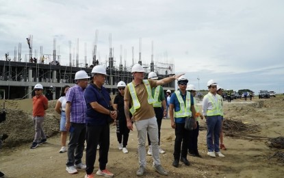 <p><strong>LOW-COST HOUSING</strong>. Laoag City Mayor Michael Keon (front row, in navy blue polo shirt) and officials from Pag-IBIG Fund and Department of Human Settlements and Urban Development conduct an on-site inspection at the on-going construction of low-cost housing units in Barangay Talingaan, Laoag City, Ilocos Norte on June 8, 2024. The Phase 1 of the project is set to be completed in August, this year. <em>(Photo courtesy of the City Government of Laoag)</em></p>