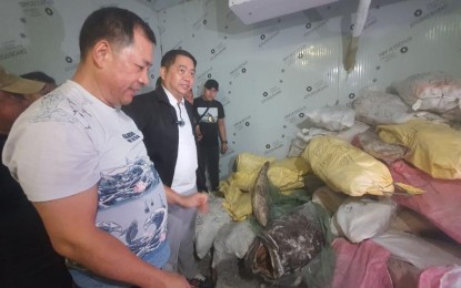 <p><strong>SMUGGLED.</strong> Agriculture Assistant Secretary Arnel de Mesa (2nd from the left) leads the inspection of 10 illegal cold storage facilities containing smuggled frozen meat and agricultural products in Kawit, Cavite on Friday (June 14, 2024). The seizure of the smuggled products was conducted in collaboration with the Bureau of Customs. <em>(Contributed photo)</em></p>