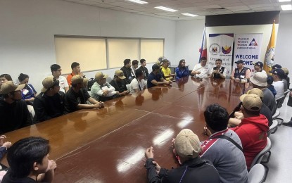 <p><strong>BACK IN PH.</strong> The 21 Filipino seafarers rescued from a Houthi-attacked ship on the Red Sea meet with government officials at the Ninoy Aquino International Airport Terminal 3 in Pasay City on June 17, 2024. They flew from Bahrain, where they were taken by a rescue US Navy ship on June 15.<em> (Photo courtesy of DMW)</em></p>
