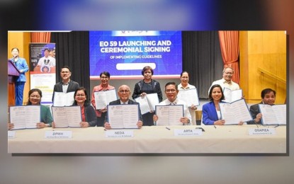 <p><strong>CUTTING RED TAPE</strong>. National Economic and Development Authority Undersecretary Joseph Capuno (3rd from left) and Anti-Red Tape Authority Secretary Ernesto Perez (3rd from right) lead the signing of the guidelines of Executive Order 59 on Tuesday (June 18, 2024) at the Philippine International Convention Center in Pasay City. EO 59 streamlines the permitting process for key infrastructure projects. <em>(Photo from NEDA)</em></p>