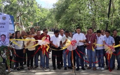 <p><strong>FARM-TO-MARKET ROAD.</strong> Mayor Reynor R. Gonzales (4th from left) and Iloilo 3rd District Rep. Lorenz R. Defensor (6th from left), joined by other officials of the municipality of Lambunao, lead the ribbon-cutting ceremony during the inauguration of the PHP20 million farm-to-market road connecting Barangays Sibacungan and Poblacion Ilaya on June 13, 2024. Gonzales said they would inaugurate four completed road projects in four remote barangays funded under the Support to Barangay Development Program of the National Task Force to End Local Communist Armed Conflict on June 21. <em>(Photo screengrab from CEC Infocenter Lambunao video)</em> </p>