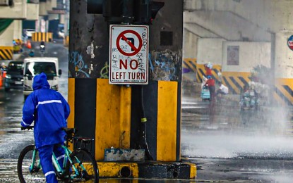 <p><strong>SAFE ZONE.</strong> A cyclist temporarily rests under a flyover amid heavy downpour in EDSA, Quezon City on June 24, 2024. Rain showers are likely to dampen most parts of the country on Wednesday (June 26, 2024) due to the intertropical convergence zone and the easterlies, the weather bureau said. <em>(PNA photo by Joan Bondoc)</em></p>