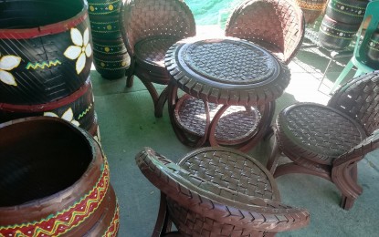 <p><strong>FOR HEALTH AND LIVELIHOOD</strong>. The pots, tables, and garden sets made from used and old tires being sold at the ongoing 23rd Matagoan Festival and 74th Foundation Day of the old municipality of Tabuk's trade fair are not just providing livelihood but also helping in eliminating mosquito breeding grounds. Jandel Taguiam, Nurse IV from the Health Promotion and Communication Services Office of Tabuk City, Kalinga Health Office on Wednesday (June 26, 2024) encourages the public to go into recycling to help address health risks while also earning. <em>(Photo by Liza T. Agoot)</em></p>