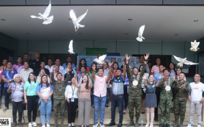 <p style="text-align: left;"><strong>PEACE. </strong>Local officials release white doves during the declaration of rebel-free status of Macrohon, Southern Leyte, on June 24, 2024. At least 21 towns in Eastern Visayas have been declared completely free from threats from the New People’s Army (NPA) and have attained Stable Internal Peace and Security (SIPS) status, the Philippine Army reported on Wednesday (June 26, 2024). (<em>Photo courtesy of Philippine Army)</em></p>