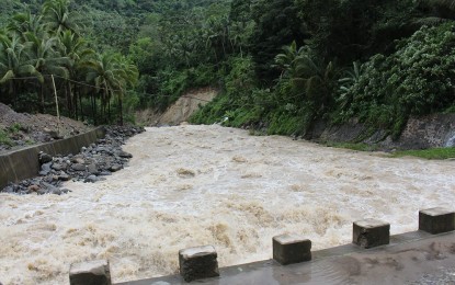<p><strong>FLASHFLOODS.</strong> Raging floodwaters threaten residents living near this river in Valencia, Negros Oriental in this undated photo. The onset of the La Niña starting in September this year is expected to bring heavy rains and deluge, the state weather bureau said. <em>(PNA file photo by Mary Judaline Flores Partlow)</em></p>