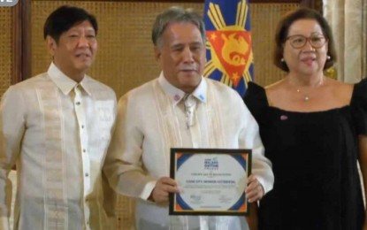<p><strong>AWARD.</strong> Cadiz City Mayor Salvador Escalante Jr. and City Social Welfare and Development Head Winona Balagosa receive from President Ferdinand R. Marcos Jr. the city’s award for its innovative and effective anti-hunger program during the 1st Walang Gutom Awards at the Ceremonial Hall of  Malacañan Palace in Manila Wednesday (June 26, 2024). The “Pagkaon Aton Tatapon (PAT): A Holistic Approach to Sustainable Food Security” was recognized in the Local Government Unit-City Level category. <em>(Screenshot from Presidential Communications Office Facebook Live)</em></p>