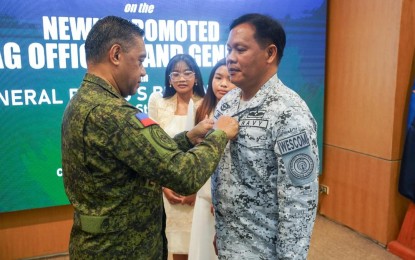 <p><strong>PROMOTED.</strong> AFP chief Gen. Romeo Brawner Jr. (left) dons the new rank on newly-promoted Western Command chief Vice Admiral Alfonso Torres Jr., (right) during the donning of ranks ceremony on Thursday (June 27, 2024) in Camp Aguinaldo, Quezon City. Three other military generals were promoted during the ceremony. <em>(Photo courtesy of the AFP)</em></p>