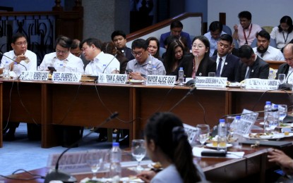 <p><strong>DUBIOUS PERSONALITY.</strong> Mayor Alice Guo (5th from left) of Bamban, Tarlac appears before a Senate hearing in Pasay City on May 22, 2024. Senator Risa Hontiveros said Guo is a fake Filipino after the National Bureau of Investigation confirmed Thursday (June 27, 2024) that the suspended mayor and a certain Chinese national Guo Hua Ping have matching fingerprints. <em>(PNA photo by Avito C. Dalan)</em></p>