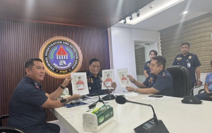 <p><strong>NABBED.</strong> Criminal Investigation and Detection Group chief Maj. Gen. Leo Francisco (center) shows the photos of the three suspects who were arrested in General Santos City for name-dropping ranking police officials in their extortion schemes, in a press briefing at Camp Crame on Friday (June 28, 2024). Francisco said they are also looking into whether the suspects are a part of a bigger syndicate, as well as the possible involvement of ranking police officials in the scheme. <em>(PNA photo by Lloyd Caliwan)</em></p>
